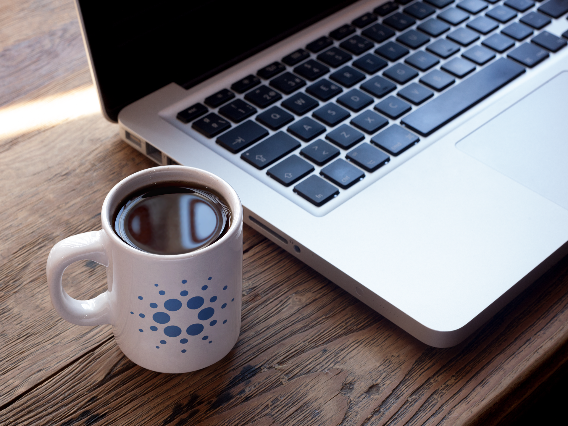 cup of coffee mockup near a macbook a16461